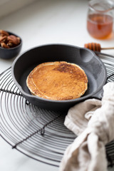 Pancakes with banana, walnuts and honey. Morning concept