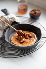 Pancakes with banana, walnuts and honey. Morning concept