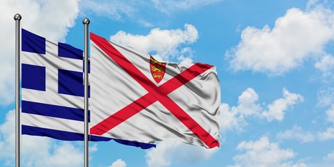 Greece and Jersey flag waving in the wind against white cloudy blue sky together. Diplomacy...