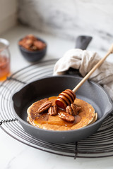 Pancakes with banana, walnuts and honey. Morning concept