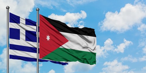 Greece and Jordan flag waving in the wind against white cloudy blue sky together. Diplomacy concept, international relations.