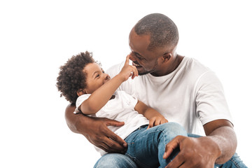 cheerful african american boy touching nose of happy father isolated on white