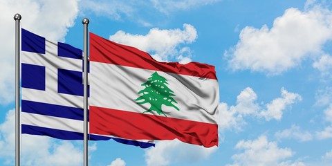 Greece and Lebanon flag waving in the wind against white cloudy blue sky together. Diplomacy concept, international relations.