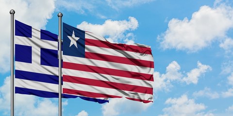 Greece and Liberia flag waving in the wind against white cloudy blue sky together. Diplomacy concept, international relations.