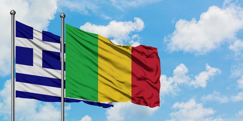 Greece and Mali flag waving in the wind against white cloudy blue sky together. Diplomacy concept, international relations.