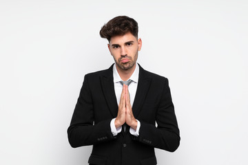 Young businessman over isolated white background pleading