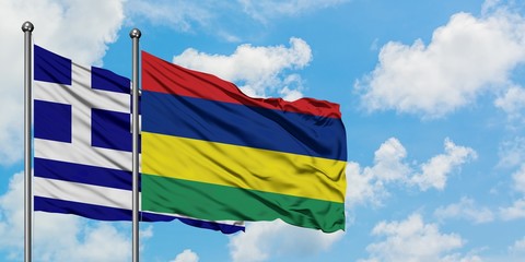 Greece and Mauritius flag waving in the wind against white cloudy blue sky together. Diplomacy concept, international relations.