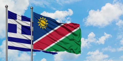 Greece and Namibia flag waving in the wind against white cloudy blue sky together. Diplomacy concept, international relations.