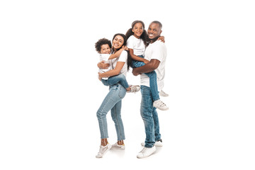 Obraz premium happy african american woman holding son, and husband holding daughter on white background