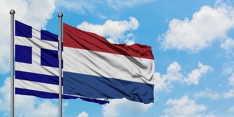 Greece and Netherlands flag waving in the wind against white cloudy blue sky together. Diplomacy concept, international relations.