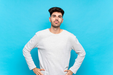 Young man over isolated blue background angry