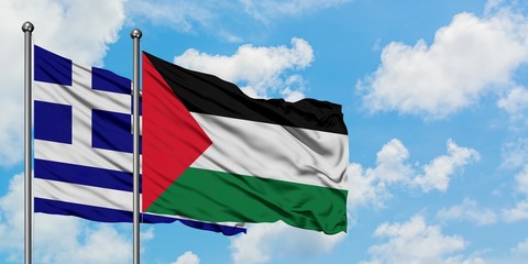 Greece and Palestine flag waving in the wind against white cloudy blue sky together. Diplomacy concept, international relations.