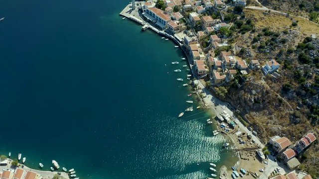 Aerial beautiful picturesque houses of Simi island Greece, bird's eye view of historical dollhouses, Greek flavor, bright Sunny weather from drone