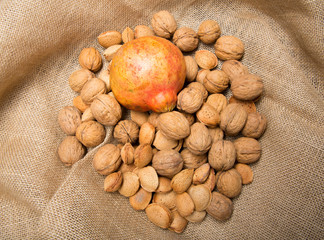Still life with nuts and almonds on brown background