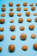 Still life with nuts and almonds on blue background