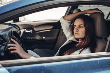 Fashion Stylish Driver Girl in White Suit Sitting in the Car