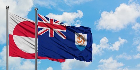 Greenland and Anguilla flag waving in the wind against white cloudy blue sky together. Diplomacy concept, international relations.