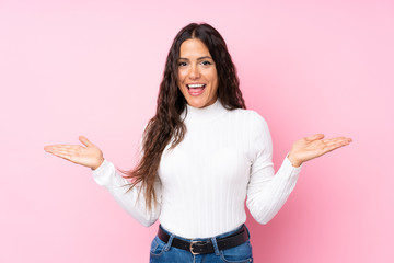 Young woman over isolated pink background with shocked facial expression