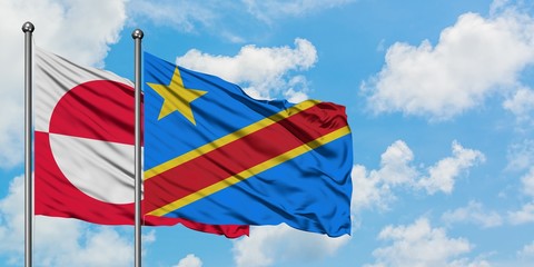 Greenland and Congo flag waving in the wind against white cloudy blue sky together. Diplomacy concept, international relations.