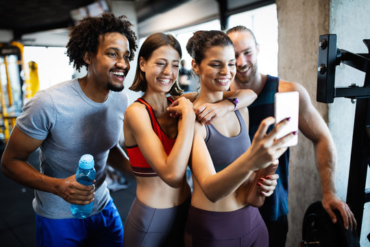 Group of friends having fun at the gym, making a selfie