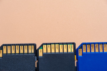 Close-up three memory cards lie on a beige table