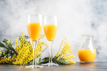 Spring alcohol cocktail mimosa with orange juice and cold dry champagne or sparkling wine in...