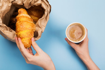 Breakfast to go - croissants and coffee with milk on blue background. Top view - obrazy, fototapety, plakaty