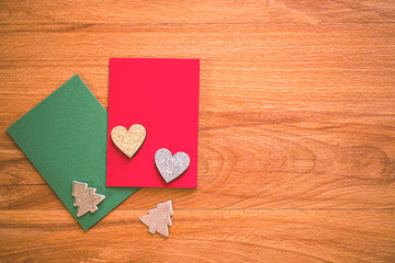 Christmas decorations with green and red card on wooden floor, image for Christmas and new year Holidays concept.