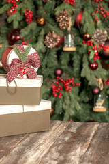Christmas background, a gift lies on a wooden board on the background of a Christmas tree