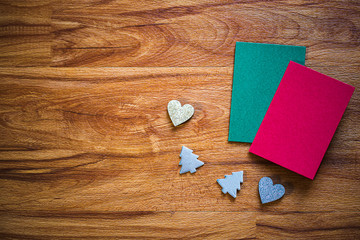 Christmas decorations with green and red card on wooden floor, image for Christmas and new year Holidays concept.