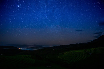 The terraced golden rice field with stars and mountain in the night at Ban Pa Pong Piang village in...