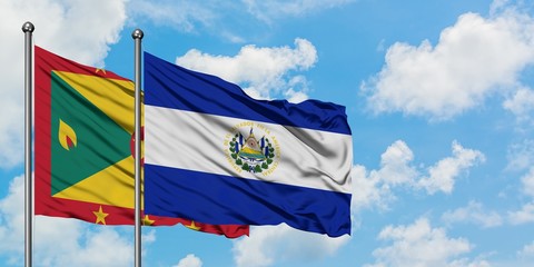 Grenada and El Salvador flag waving in the wind against white cloudy blue sky together. Diplomacy concept, international relations.