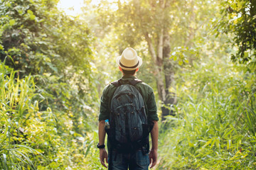Young traveler wearing a hat with backpack hiking outdoor Travel Lifestyle and Adventure concept.