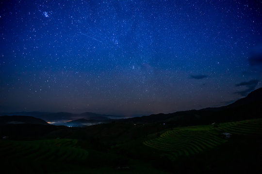 The terraced golden rice field with stars and mountain in the night at Ban Pa Pong Piang village in Mae Chaem, Chiang Mai province, Thailand..