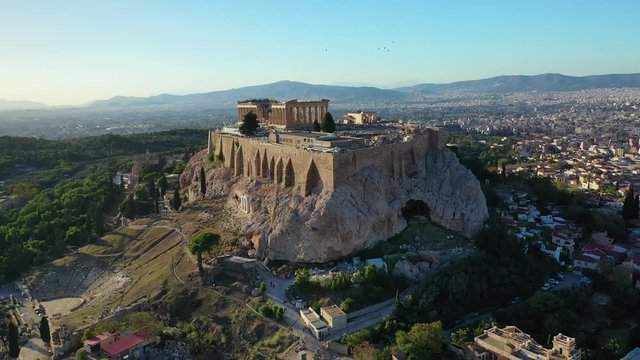 Aerial drone video of iconic Acropolis hill featuring Masterpiece of Ancient world - the Parthenon, Athens historic centre, Attica, Greece