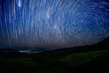Star Trail over the terraced golden rice field at Ban Pa Pong Piang village in Mae Chaem, Chiang Mai province, Thailand.