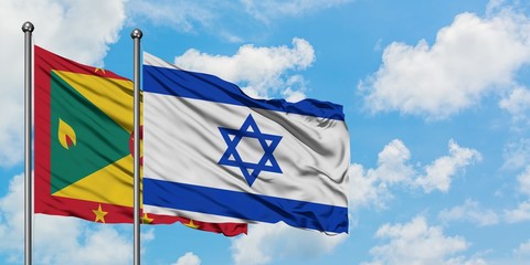 Grenada and Israel flag waving in the wind against white cloudy blue sky together. Diplomacy concept, international relations.