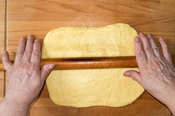 Woman rolling dough for  baking