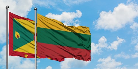 Grenada and Lithuania flag waving in the wind against white cloudy blue sky together. Diplomacy concept, international relations.