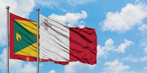 Grenada and Malta flag waving in the wind against white cloudy blue sky together. Diplomacy concept, international relations.