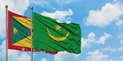 Grenada and Mauritania flag waving in the wind against white cloudy blue sky together. Diplomacy concept, international relations.
