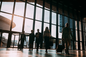Group of business people walking in airport hall