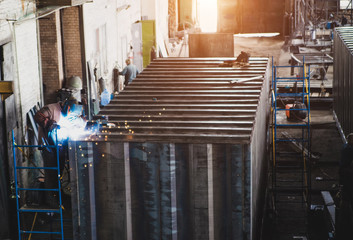 Welder collects a large metal container