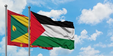 Grenada and Palestine flag waving in the wind against white cloudy blue sky together. Diplomacy...