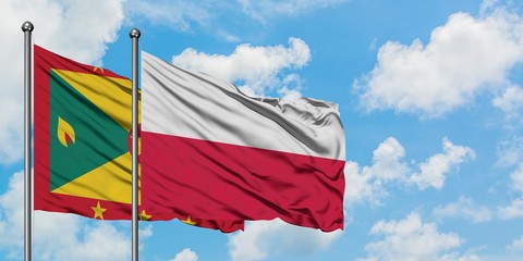 Grenada and Poland flag waving in the wind against white cloudy blue sky together. Diplomacy concept, international relations.