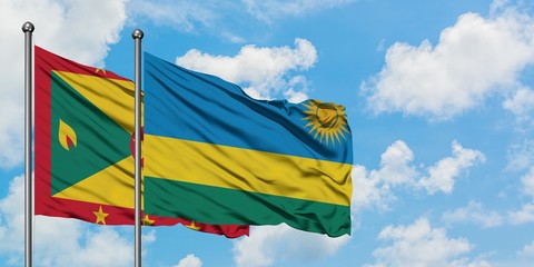 Grenada and Rwanda flag waving in the wind against white cloudy blue sky together. Diplomacy concept, international relations.