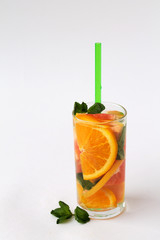 orange cocktail with green mint on white background. Detox citrus cocktail. healthy lifestyle.