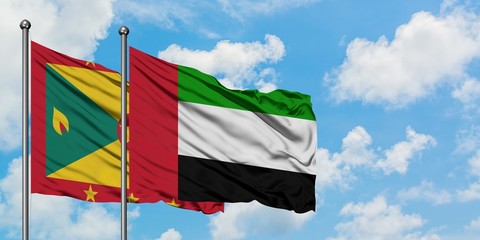 Grenada and United Arab Emirates flag waving in the wind against white cloudy blue sky together. Diplomacy concept, international relations.
