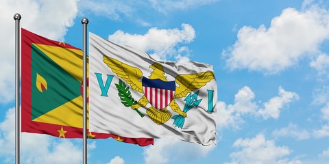 Grenada and United States Virgin Islands flag waving in the wind against white cloudy blue sky together. Diplomacy concept, international relations.