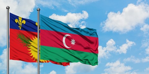 Guadeloupe and Azerbaijan flag waving in the wind against white cloudy blue sky together. Diplomacy...